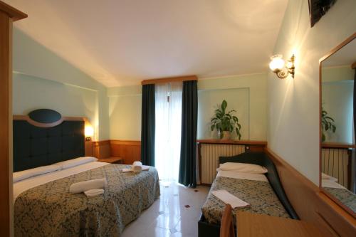 Кровать или кровати в номере Hotel Il Vecchio Pescatore