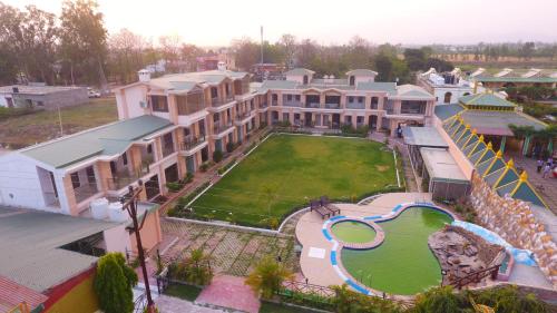 an aerial view of a mansion with a large yard at La Bellevue (Club & Resort) in Rāmnagar