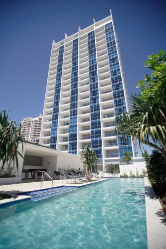 a hotel with a swimming pool in front of a building at Ocean Pacific Resort - Official in Gold Coast