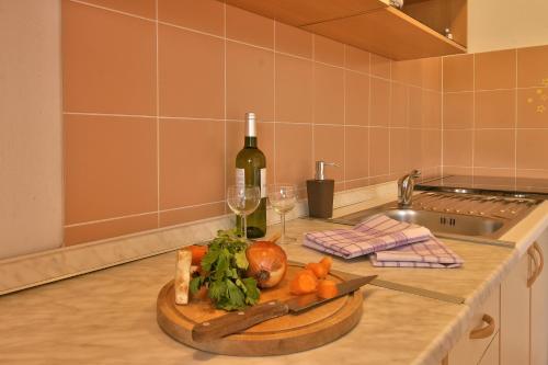 a kitchen counter with a cutting board with a bottle of wine at Apartment Borik in Pula