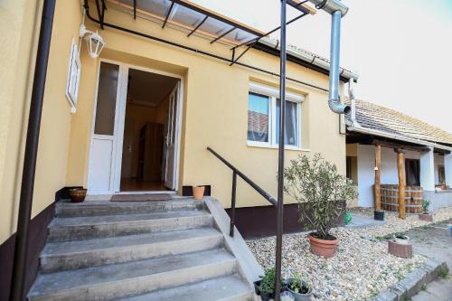 a house with stairs leading to the door at Rózsa Vendégház in Tokaj