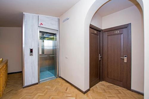 an entrance to a hallway with a wooden door at Yerevan Boutique Hotel in Yerevan
