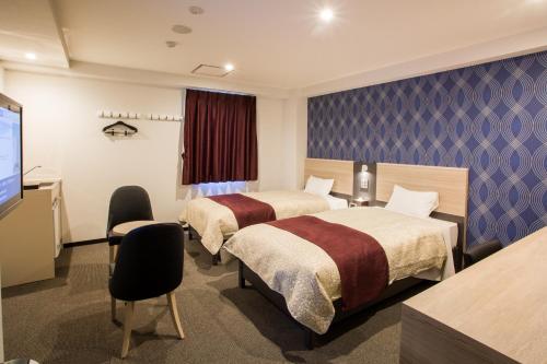 מיטה או מיטות בחדר ב-Kuretake Inn Premium Fujinomiya