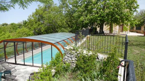 a swimming pool with a slide in a yard at Le Bosquet in Aiguines
