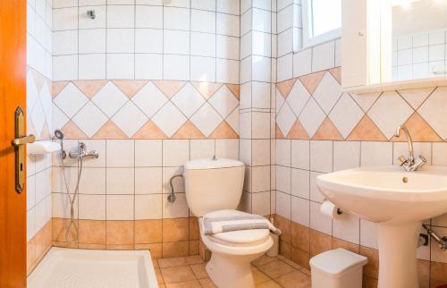 La salle de bains est pourvue de toilettes et d'un lavabo. dans l'établissement Pelagos Studios, à Amoudi