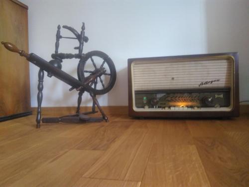 a tv sitting on the floor next to a bike at Nađ Holiday Home in Privlaka
