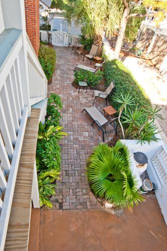 an outdoor patio with chairs and tables and plants at DeSoto Beach Gardens in Tybee Island