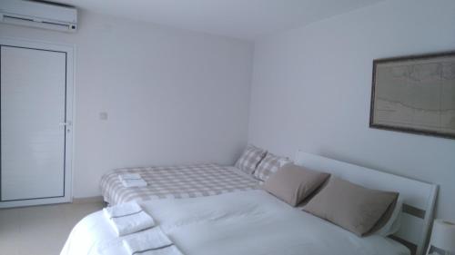 a bed in a white room with at Monte Girassol - The Lisbon Country House in Quinta das Faias