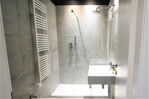 a bathroom with a shower and a sink and a toilet at MARCONI 1935 in Follonica
