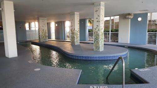 a swimming pool in the middle of a building at JeffsCondos - 5 Bedroom - Ocean Blue Resort in Myrtle Beach