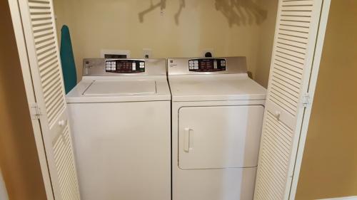 a small laundry room with a washer and dryer at JeffsCondos - 5 Bedroom - Ocean Blue Resort in Myrtle Beach