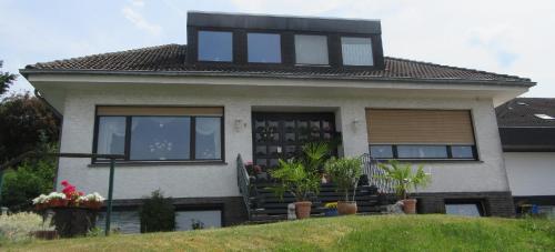 a house with black windows on top of it at Kermeterblick in Schleiden