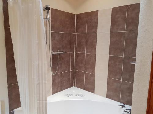 a bathroom with a shower with a toilet in it at Breadalbane Suites in Wick