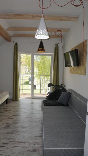 a bedroom with a bed and a large window at Apartamenty Oaza in Rewal