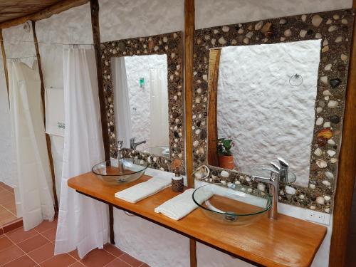 a bathroom with two sinks and a large mirror at Posada Turistica Dantayaco in Mocoa