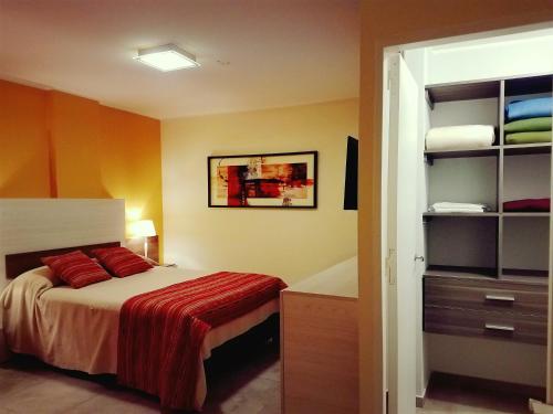 a bedroom with a bed and a dresser at Edificio NIZA I in Villa Carlos Paz