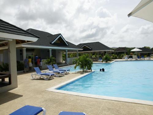 a pool at a resort with people in the water at Jamnick Vacation Rentals - Fern Court, Richmond Estate, St Ann, Jamaica in Ocho Rios