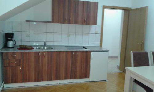 a kitchen with a sink and a counter top at Apartment VILLA MERCI in Sarajevo
