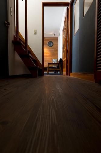 an open hallway with a staircase and a table at Sano-san-chi in Izumi-Sano