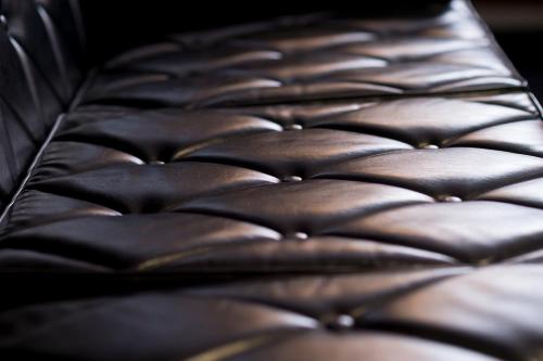 a close up of the back of a leather chair at Sano-san-chi in Izumi-Sano