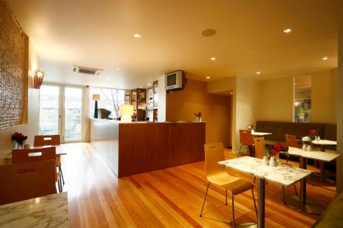 a dining room and kitchen with a table and chairs at Best Western Plus The Tudor Box Hill in Box Hill