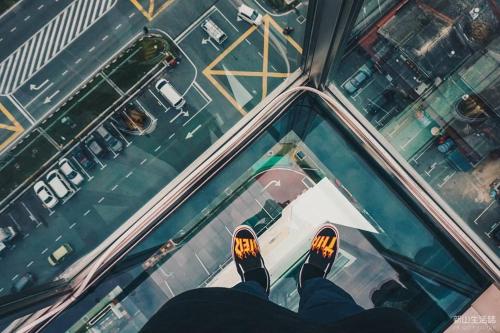 a person standing on the glass floor of a building at Amerin Hotel Johor Bahru in Johor Bahru