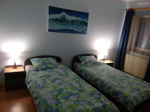 two beds sitting next to each other in a bedroom at Anette House in Pärnu