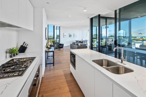 a kitchen with a sink and a counter top at Anchorage Apartments Hampton in Melbourne