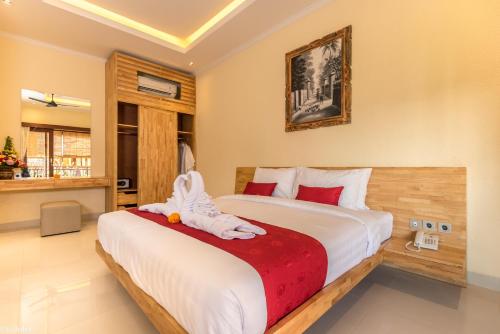 a bedroom with a bed with a stuffed animal on it at Bliss Ubud Abangan in Ubud