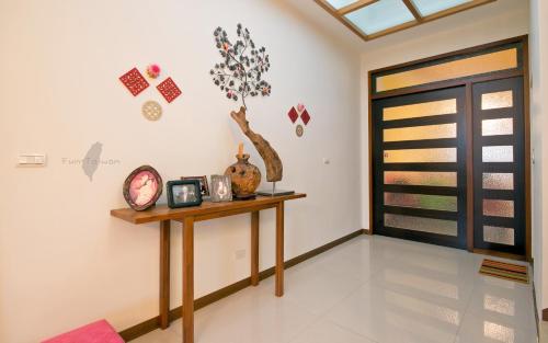 a living room with a table and a door at Pure Farm B&B No0856 in Zhuangwei