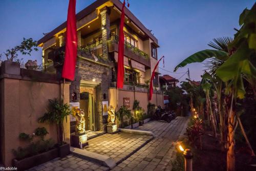 a building with red flags on the side of it at Bliss Ubud Abangan in Ubud