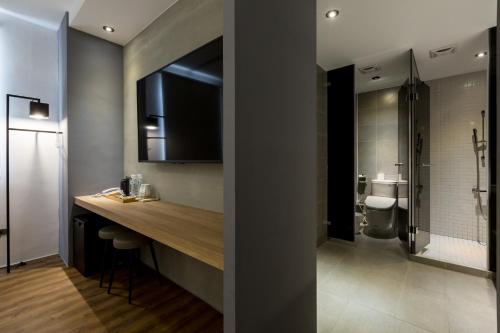 a bathroom with a sink and a toilet in a room at Green Hotel in Magong