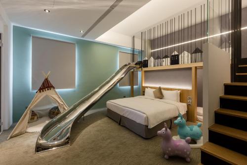 a bedroom with a bed and a slide at Green Hotel in Magong