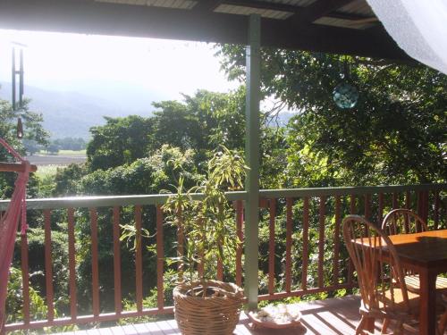 a porch with a table and chairs on a deck at Mossman Gorge Bed and Breakfast in Mossman