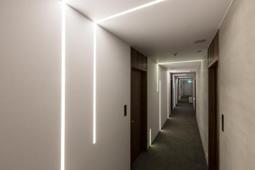 a corridor in a building with white walls and a hallway at Green Hotel in Magong