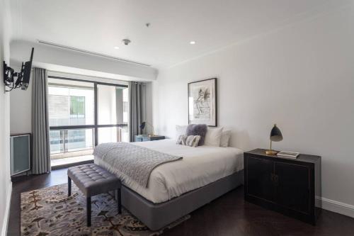 a bedroom with a large bed and a window at Heritage Luxury & Viaduct Vibe in Auckland