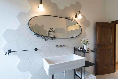a bathroom with a white sink and a mirror at Torre di Badia in Badia A Passignano