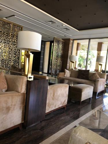 a lobby with couches and a table and lamps at Dreamland oasis in Chakvi in Chakvi