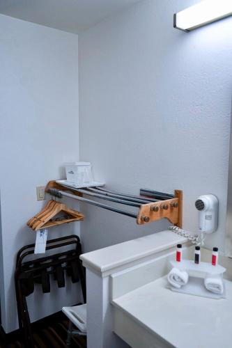 a bathroom with a white sink and a mirror at Howard Johnson by Wyndham Salinas in Salinas