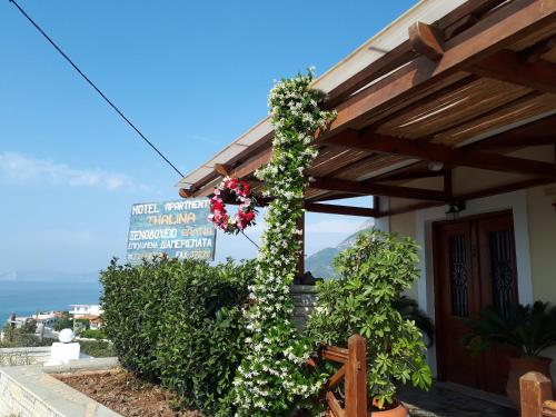 a building with flowers on the side of it at Thalina Hotel in Marathokampos