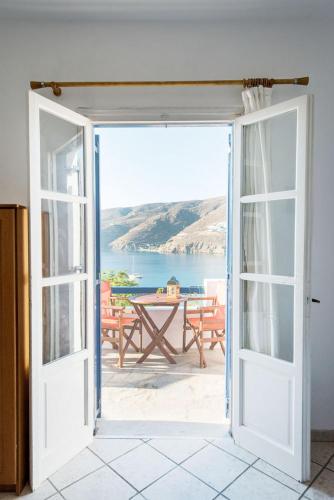 an open door leading to a patio with a table at Erisimo in Aegiali