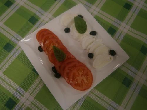 a plate of food with a sausage and vegetables at Camping Klaus in Cavallino-Treporti