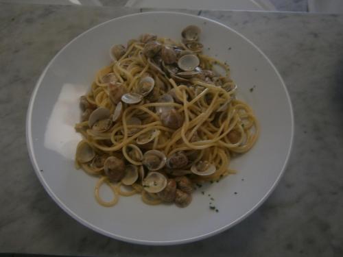 a plate of spaghetti and mushrooms on a table at Camping Klaus in Cavallino-Treporti