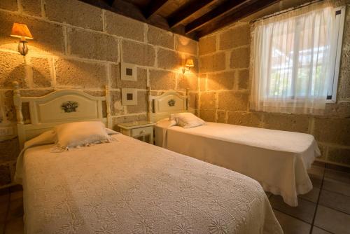 En eller flere senger på et rom på Casitas en el Paraiso