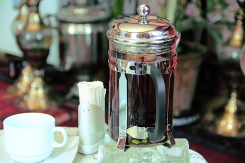 a glass blender sitting on a table with a cup at CTH-Baku-Hostel in Baku