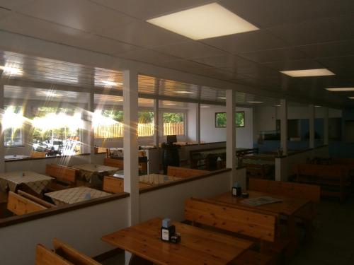 a dining room with tables and chairs and windows at Camping Klaus in Cavallino-Treporti