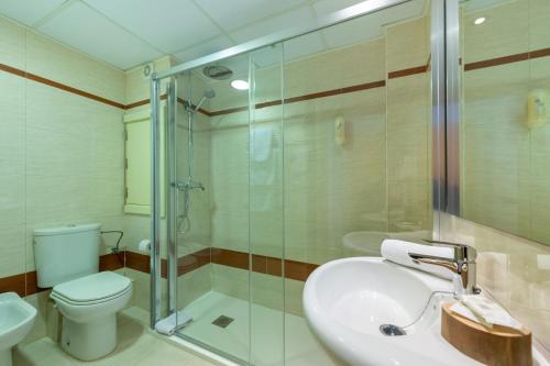 a bathroom with a toilet, sink, and shower at Hotel Vibra San Remo in San Antonio Bay