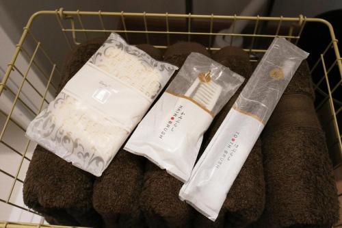 a basket with two towels and two socks at ORI stay and living in Kyoto