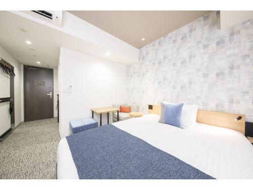 Postel nebo postele na pokoji v ubytování Tokyu Stay Takanawa Shinagawa Area