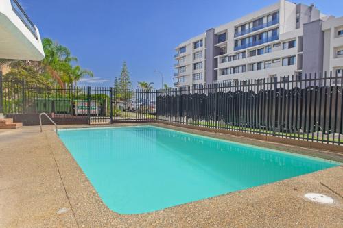 a swimming pool in front of a building at Macquarie Towers 17 1 Waugh Street in Port Macquarie